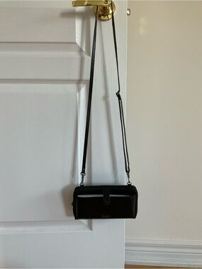 The Sak Classic Black Crossbody Wallet with Adjustable Strap **has flaw**